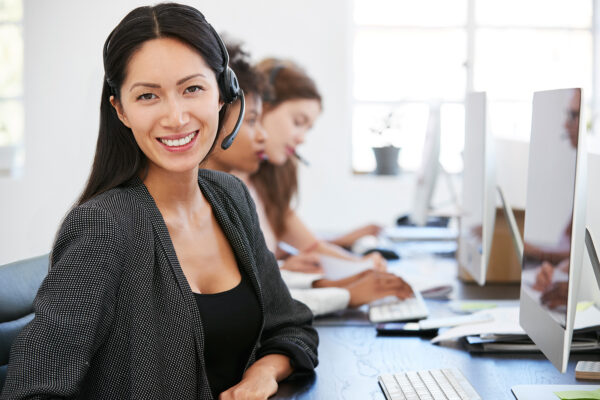 young-asian-woman-with-headset-smiling-to-camera-PL8ZF9M.jpg